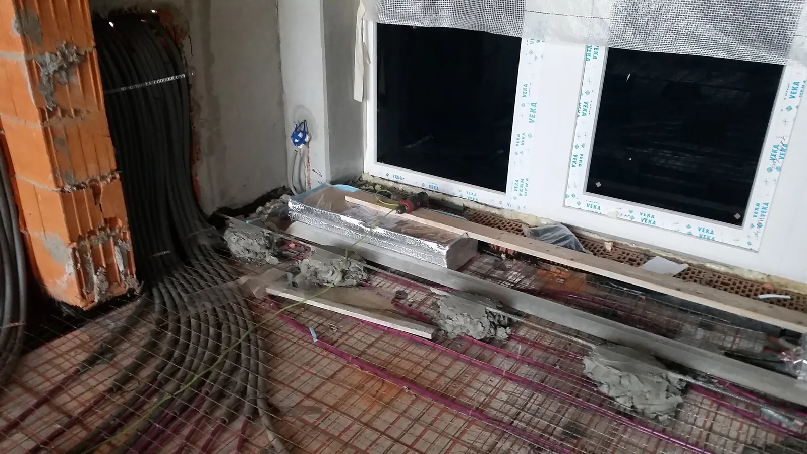 Underfloor heating loops and service runs before the screed is poured